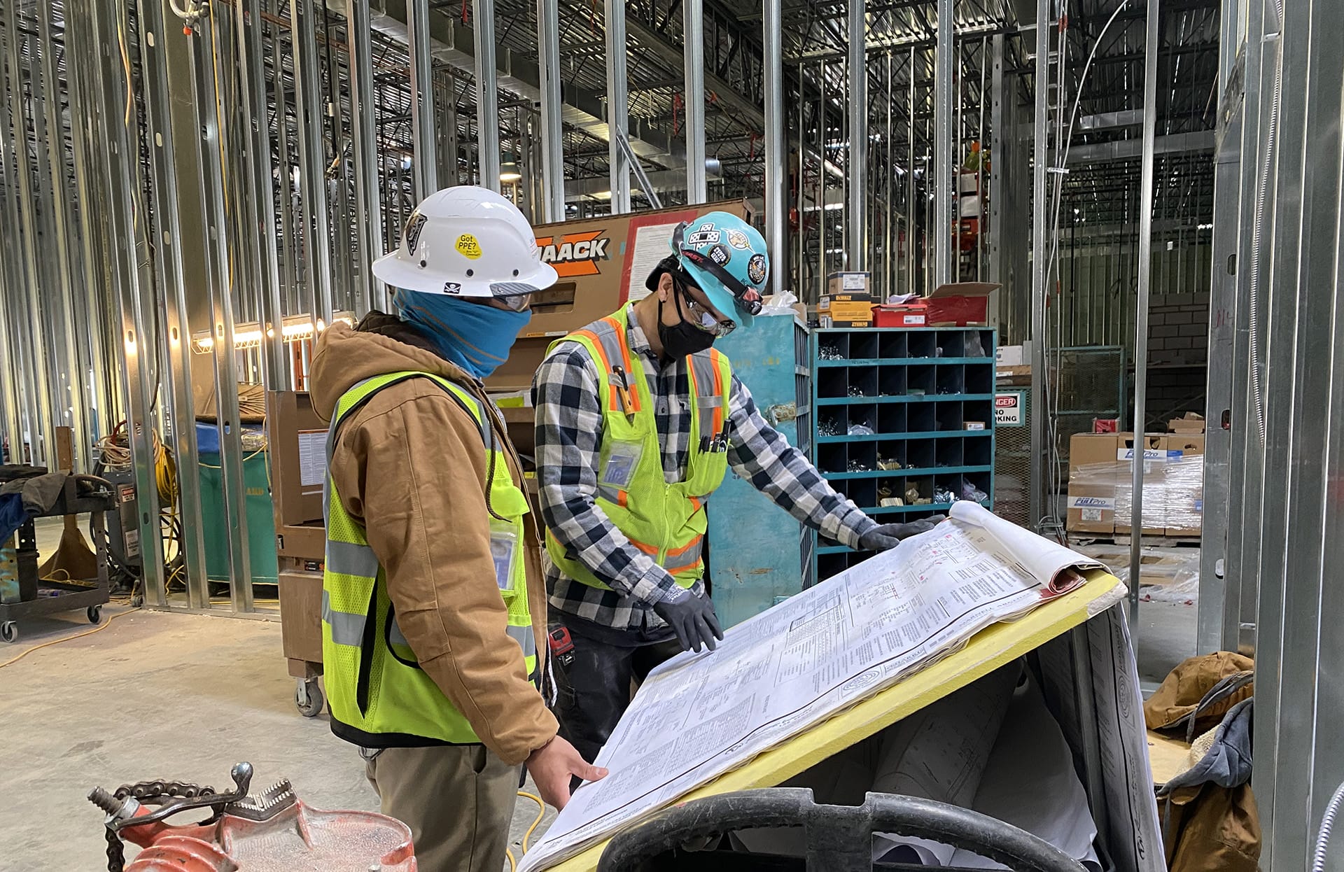 Two employees looking at plans