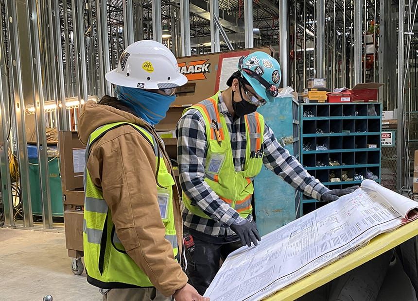 Electricians at a drawing table